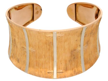 Brazalete abierto laminado en oro dos tonos 18 kilates. Fashion