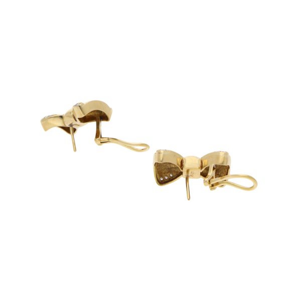 Aretes diseño especial motivo moño con diamantes en oro amarillo 18 kilates. Online now