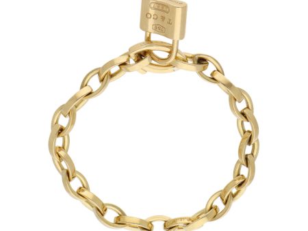 Pulsera eslabón cruzado y dije diseño especial motivo candado en oro amarillo 18 kilates. Sale