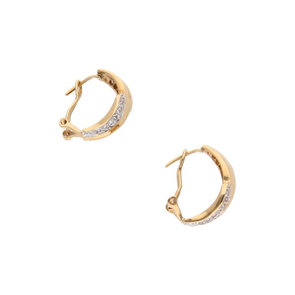 Aretes estilizados con circonias en oro amarillo 14 kilates. Supply