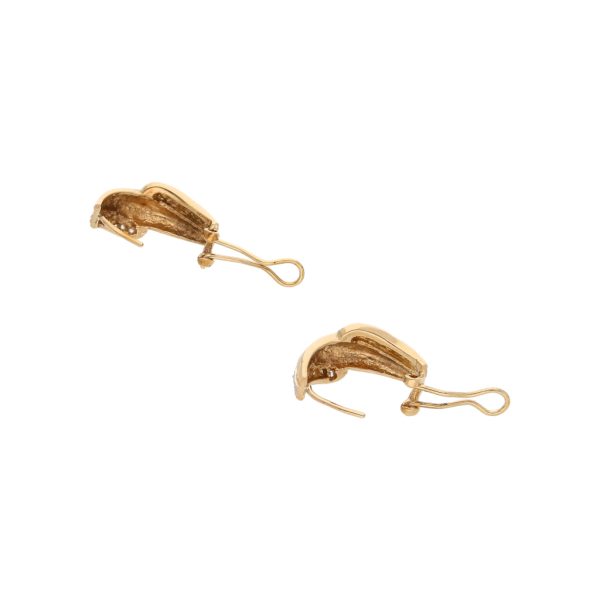 Aretes estilizados con circonias en oro amarillo 14 kilates. Supply